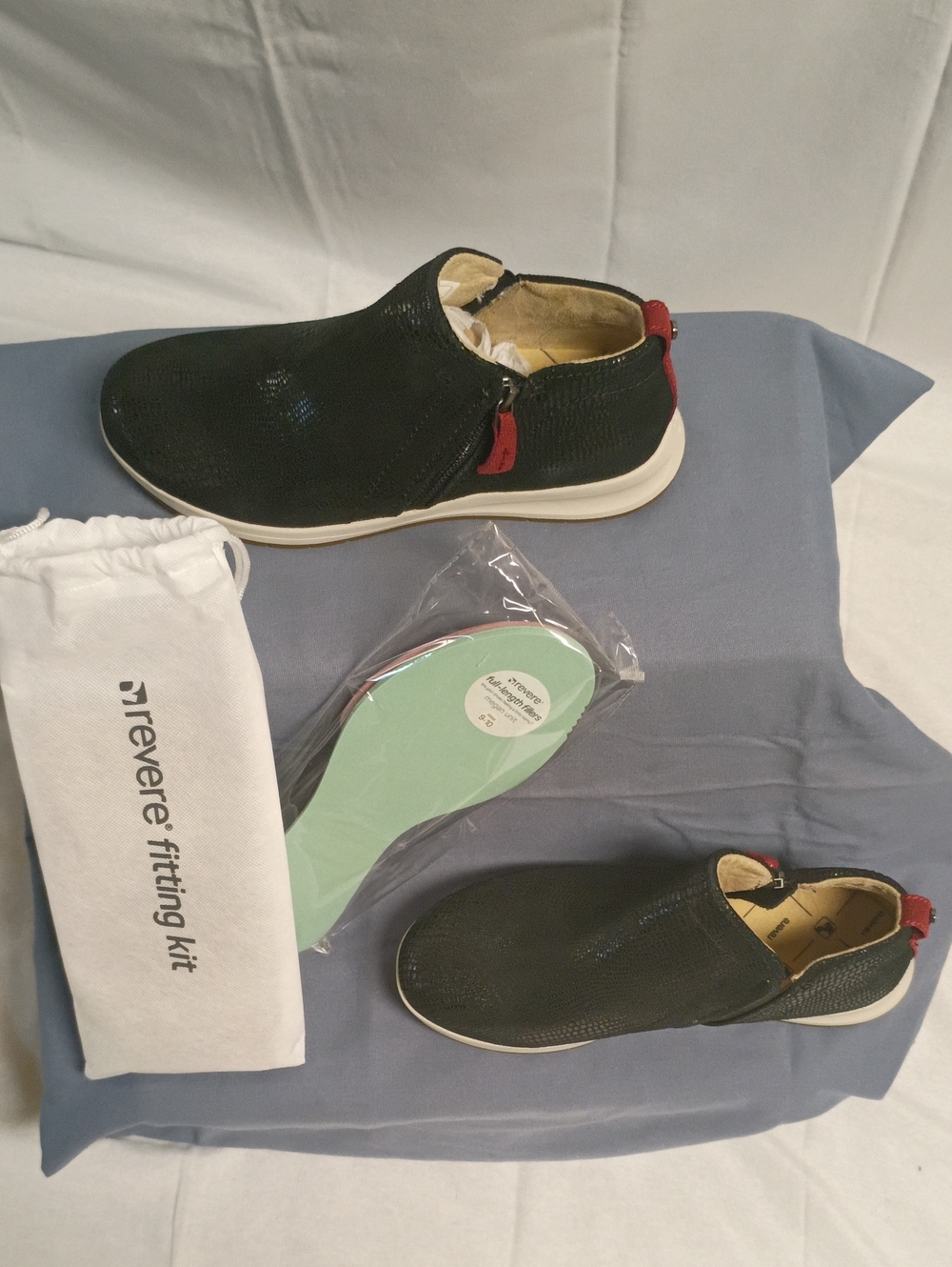 Reverse Black Slip-On Sneakers with Red Heel Accents